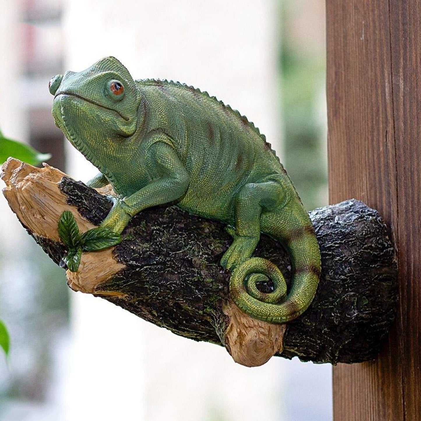 Resin chameleon figurine on the tree